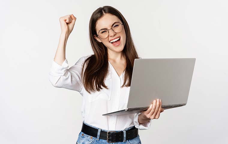 A girl with happy face carrying a laptop in hand